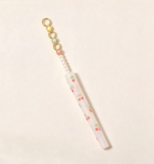 Assorted wholesale beaded joint holder sticks featuring gold rings, colorful crystal beads, and pearls on a ceramic plate