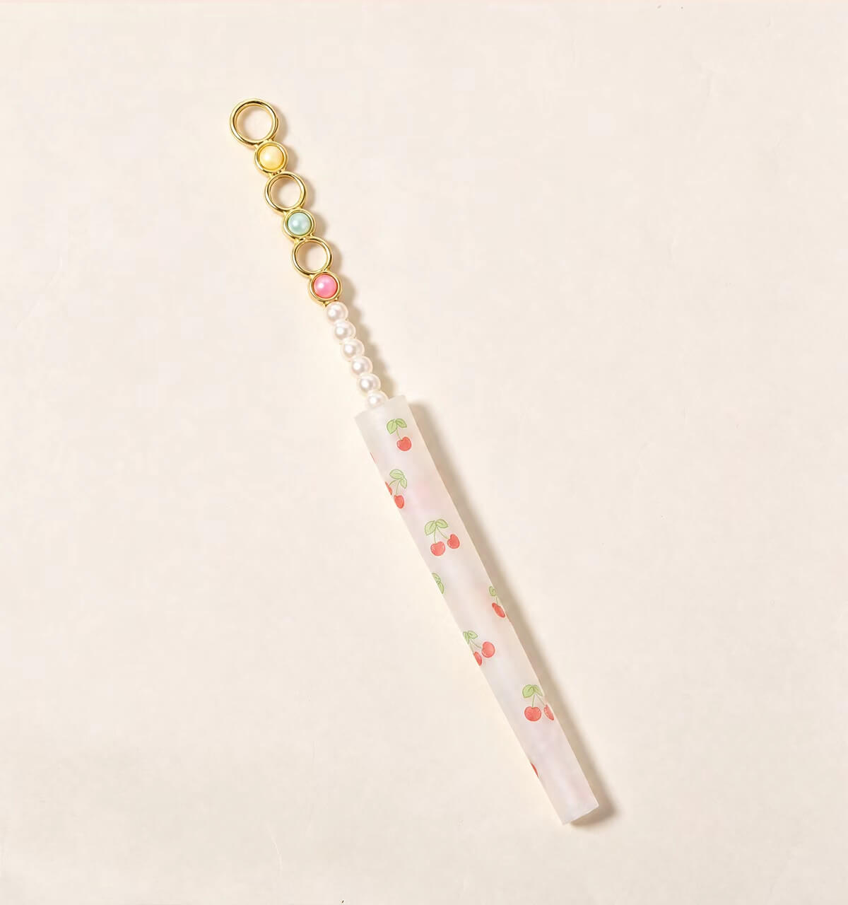Assorted wholesale beaded joint holder sticks featuring gold rings, colorful crystal beads, and pearls on a ceramic plate